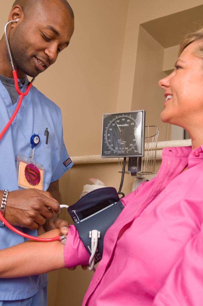 A medic taking a patient's blood pressure