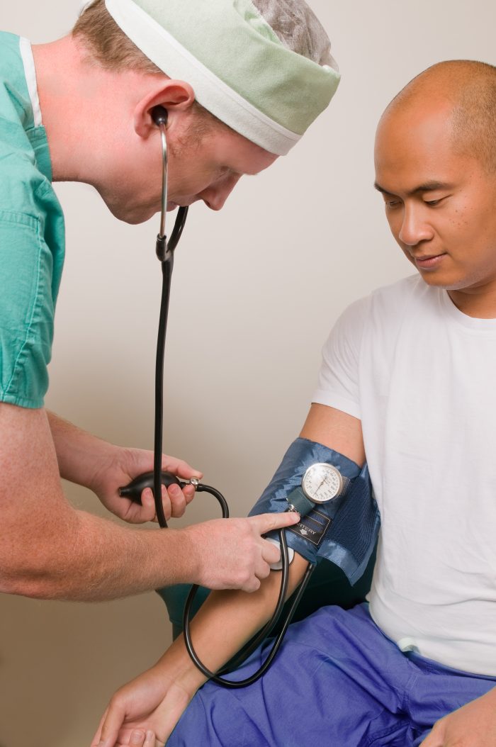 A medic taking a patient's blood pressure